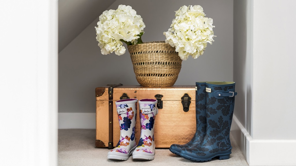 An image of wellington boots under the stairs from an example of a Latimer home.
